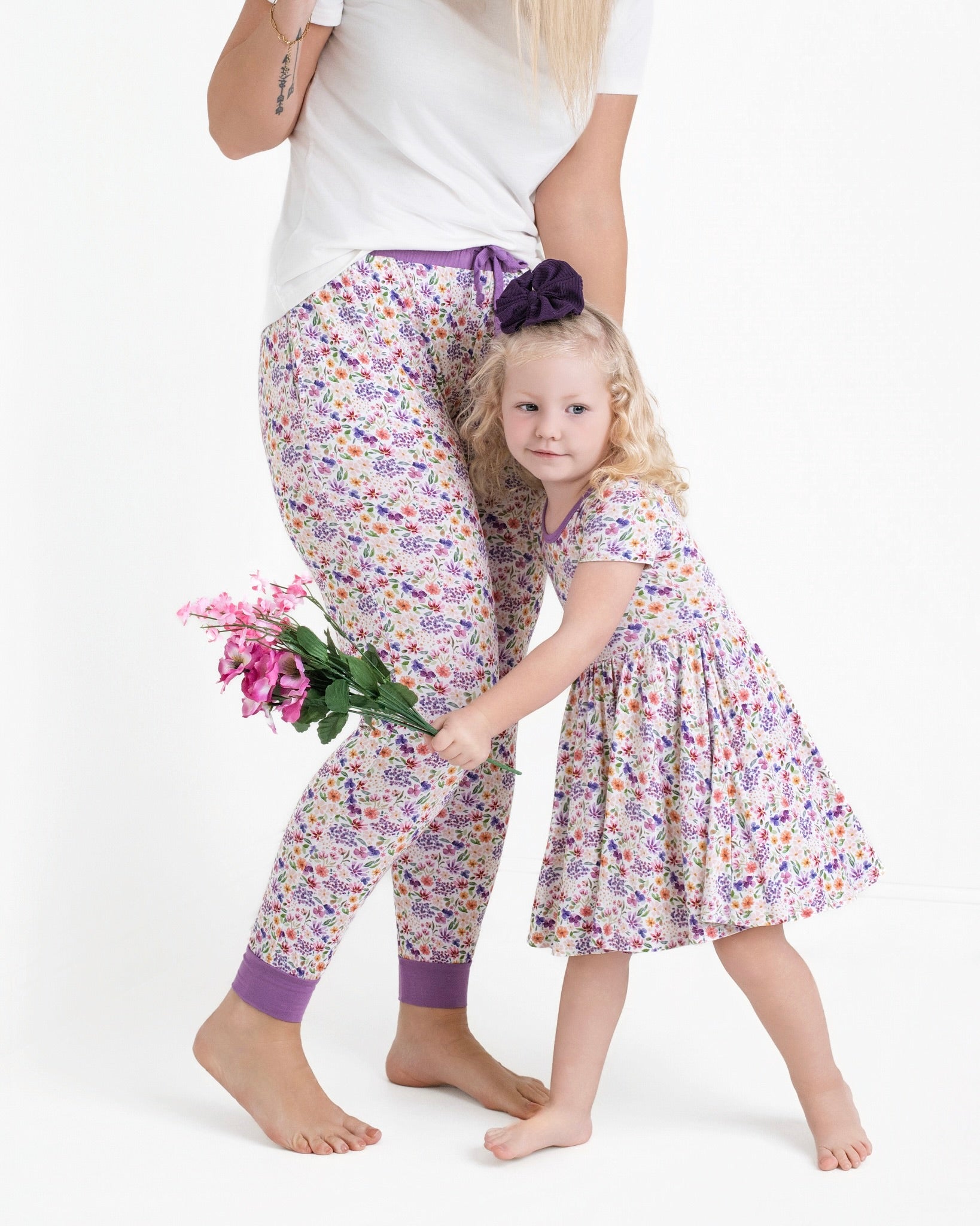 Women's floral print bamboo joggers with purple cuffs.