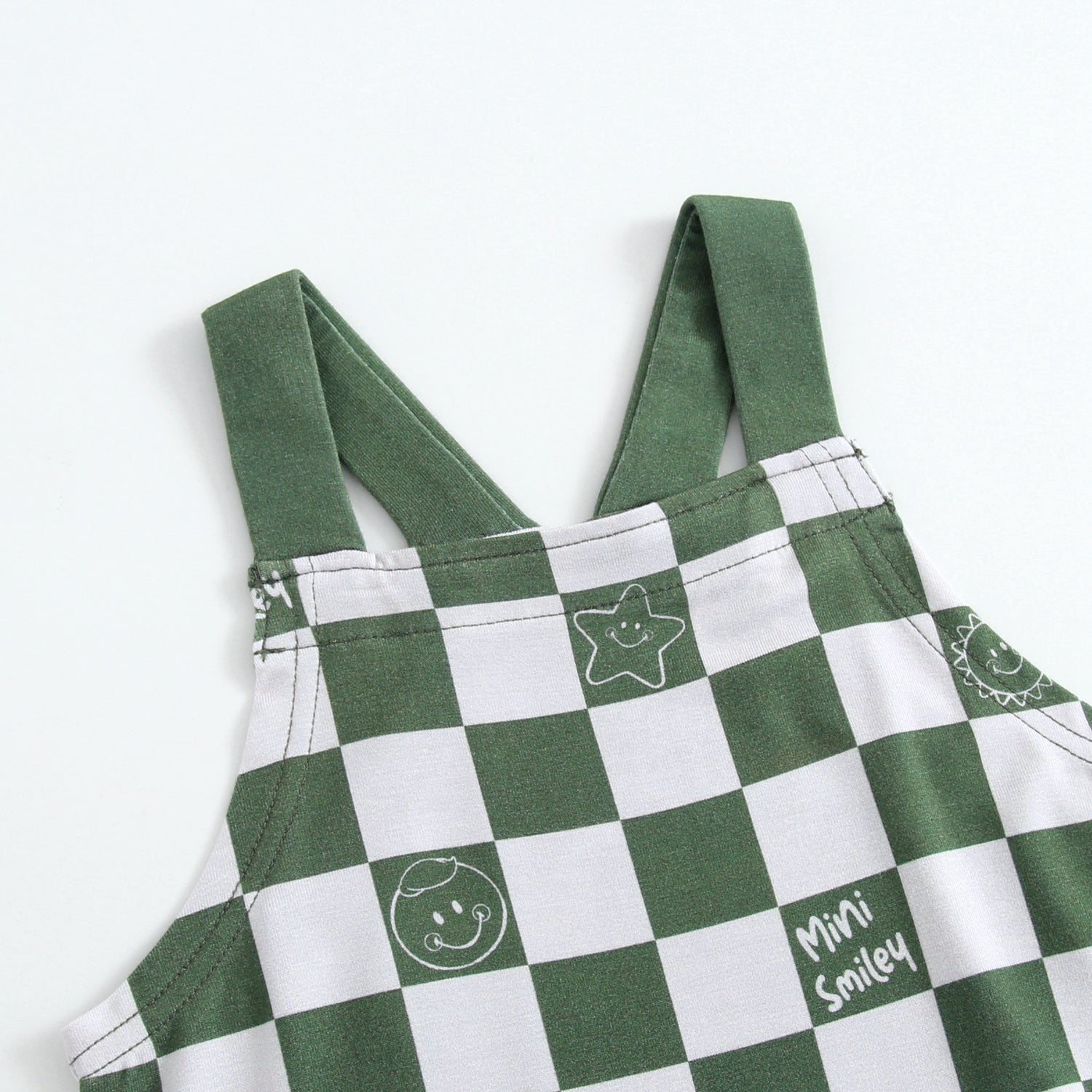 Green and white checkered overalls with smiley face graphics.
