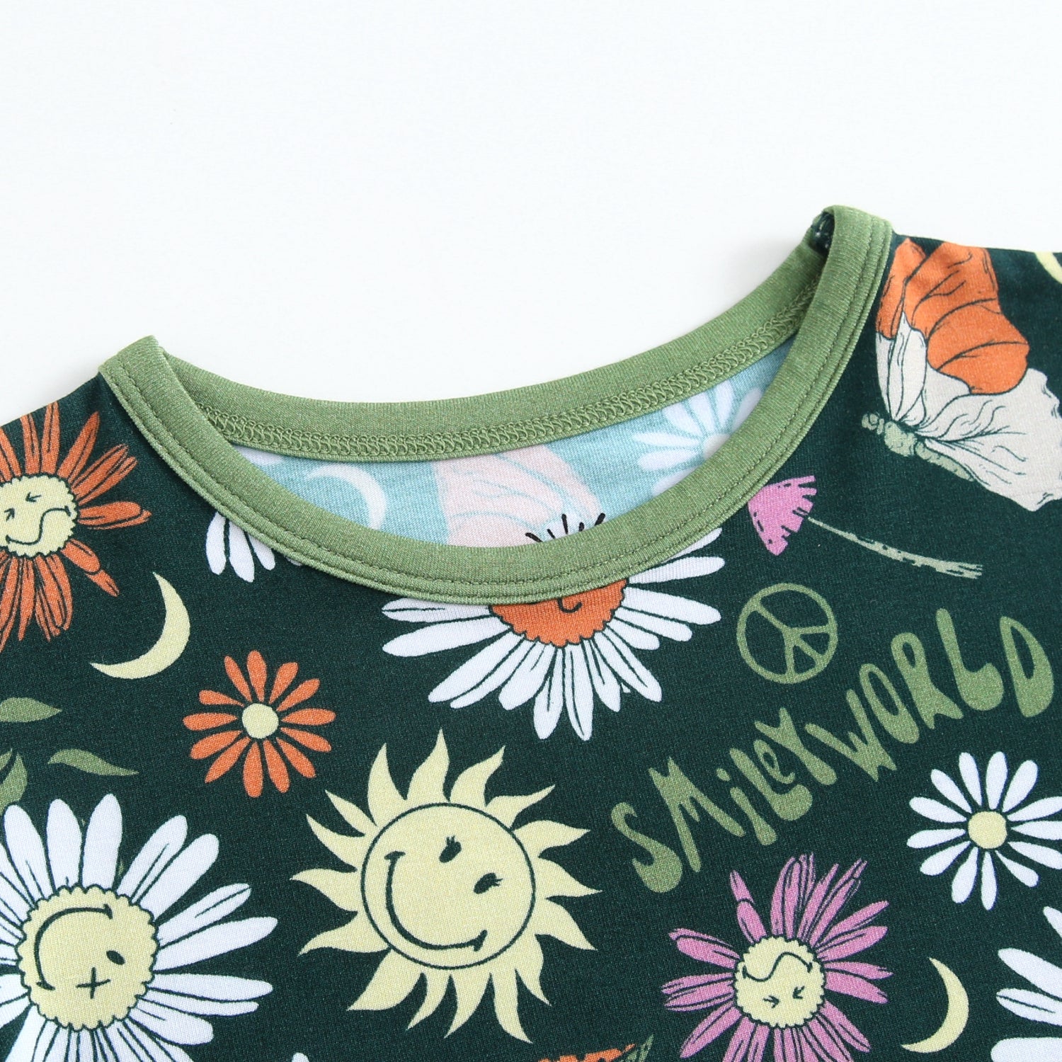Dark green pajama top with a SmileyWorld groovy floral print and green trim.