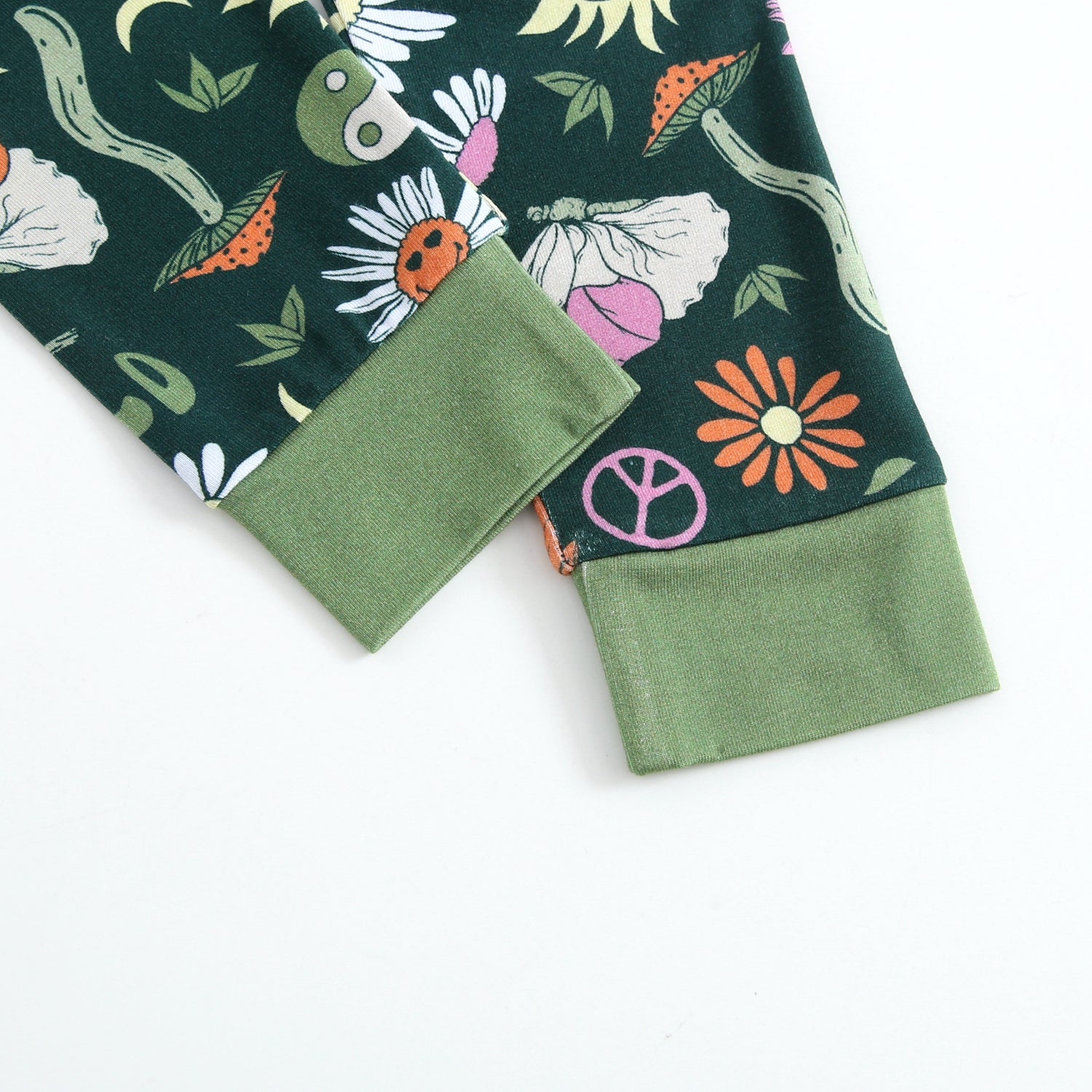 Green pajama set with groovy floral and peace sign print.