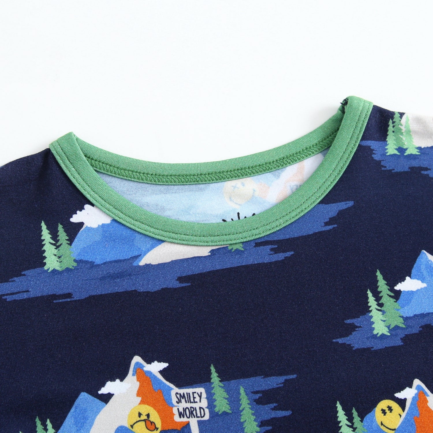 A navy blue pajama top with a green trim and a Mount SmileyWorld print.